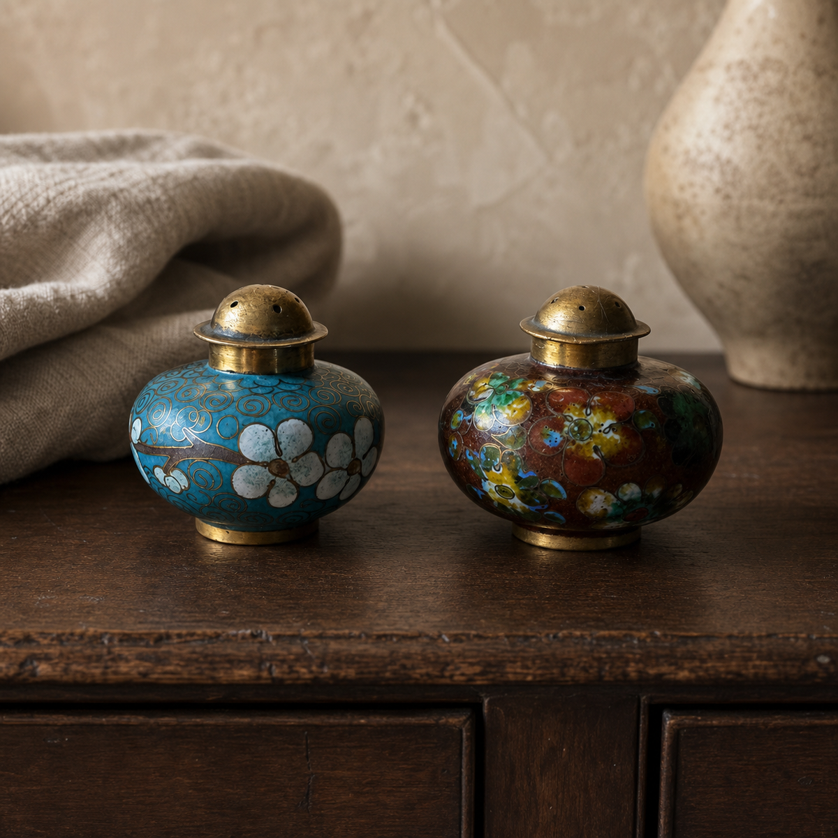 Vintage cloisonné spice shaker pair styled on dark walnut